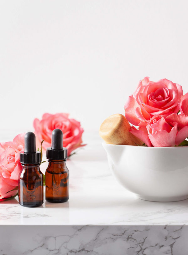essential oils in bottles rose flowers. alternative medicine aro